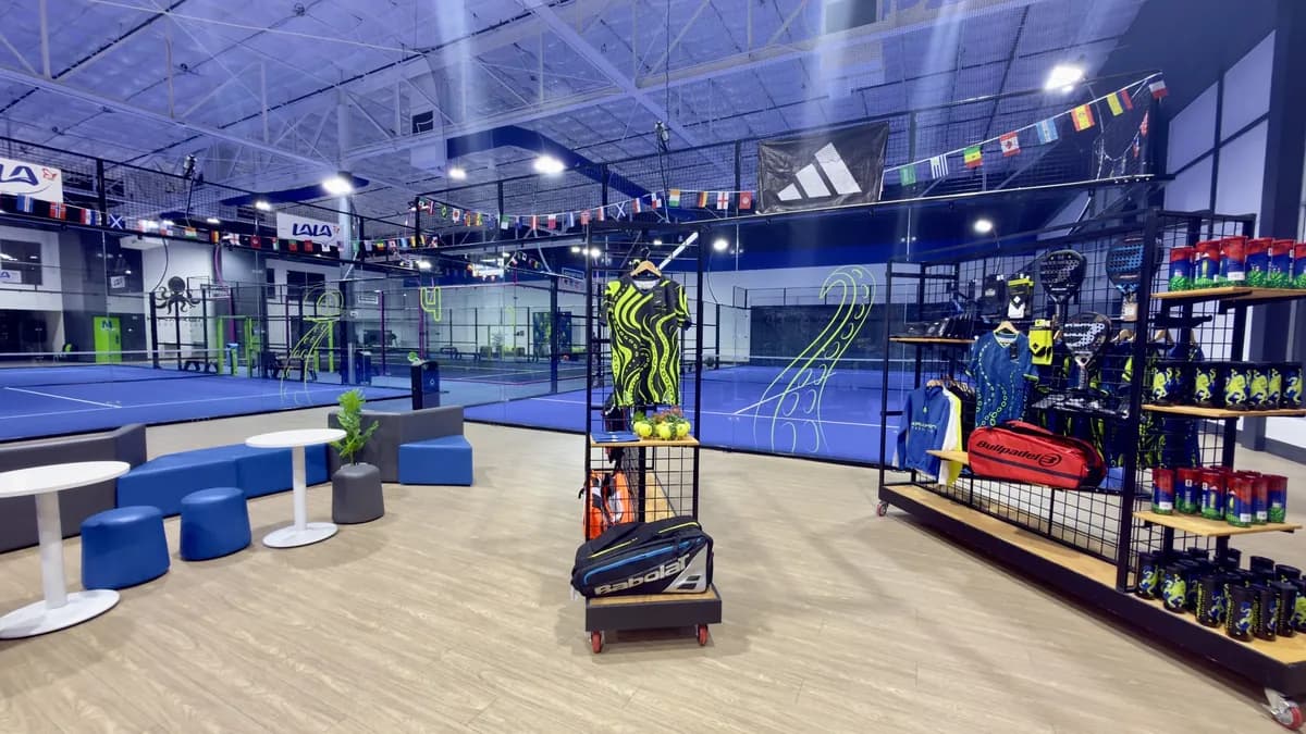The pro shop and seating beside Kraken Padel Club’s indoor courts.